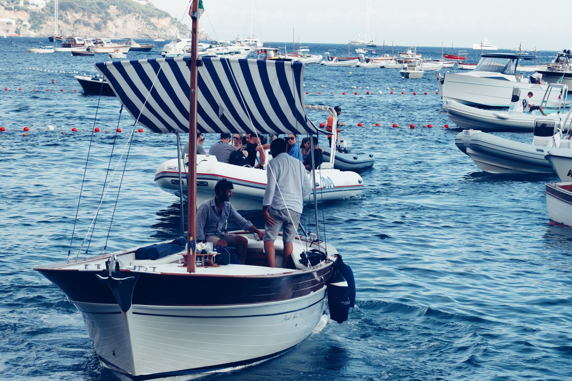 Small rental boats docked in the rocky harbor of Cala Figuera