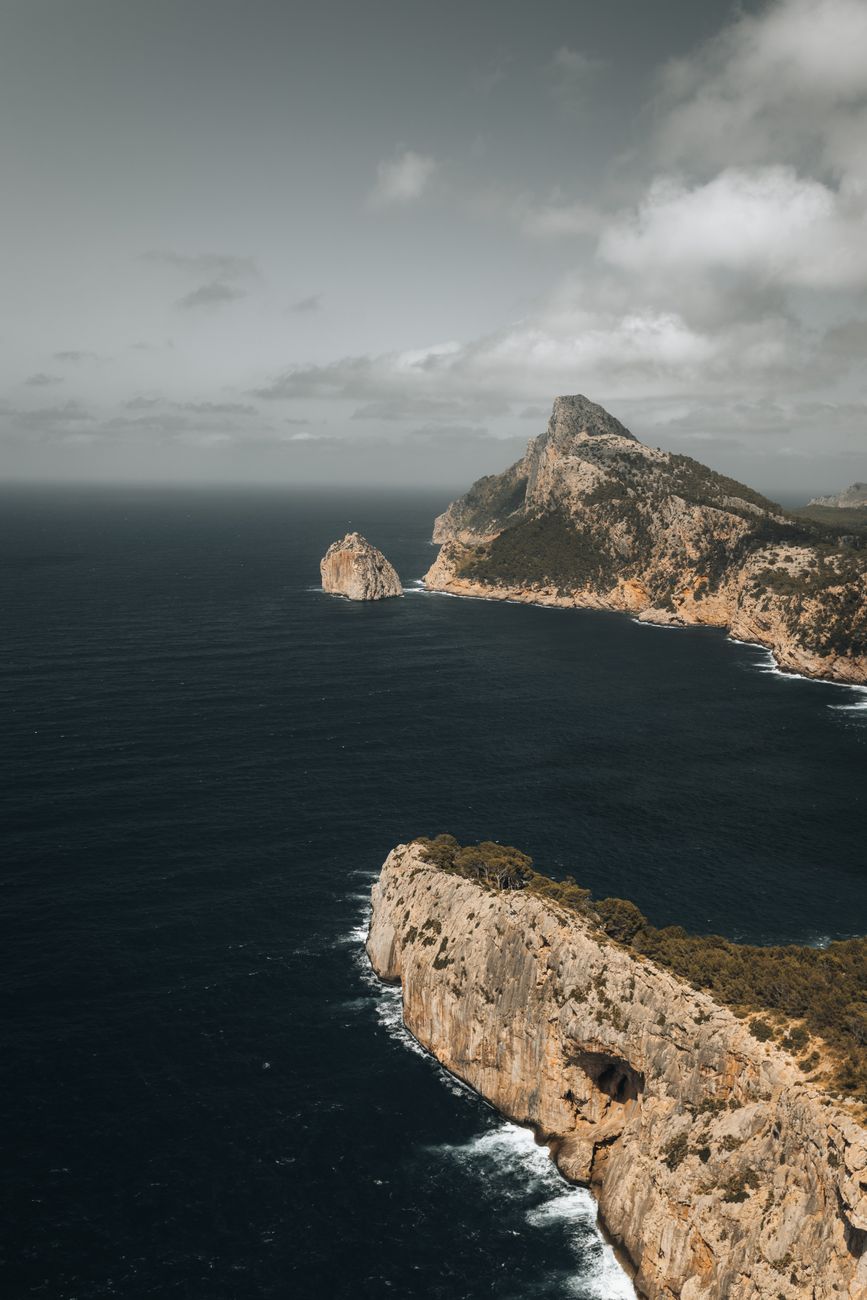 Rugged cliffs and wild waters of Cala Figuera Beach in Formentor